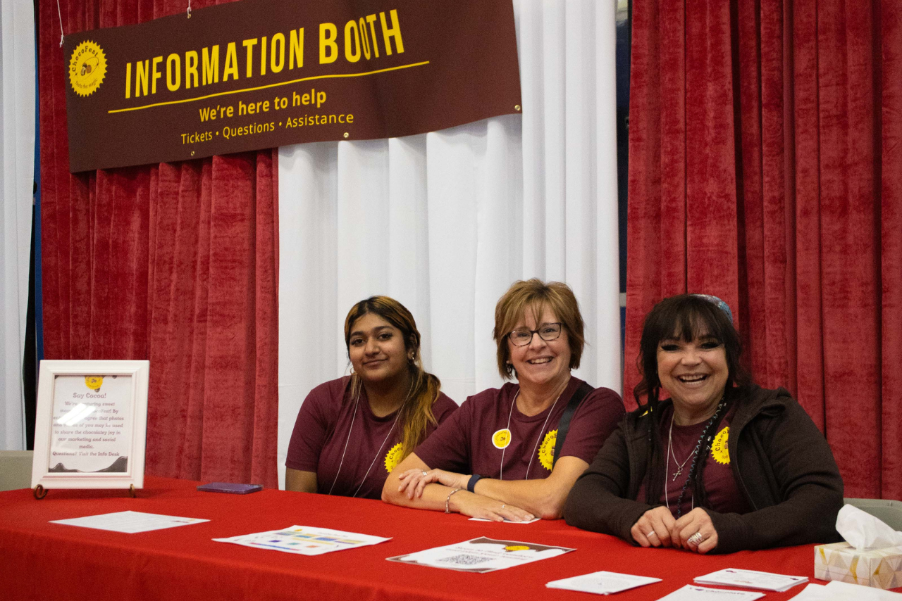 Smiling volunteers at the ChocoFest information booth