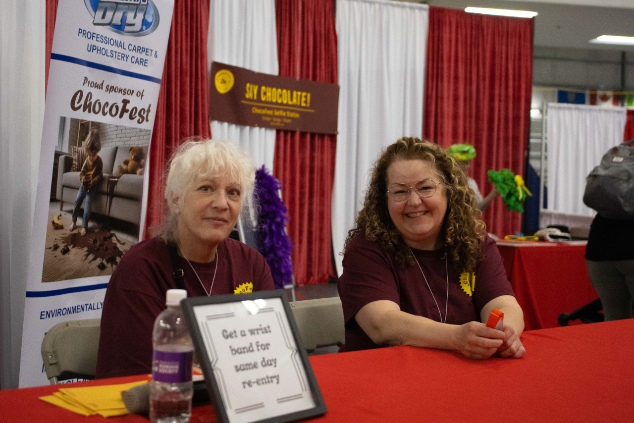 Smiling volunteers welcoming guests at ChocoFest.