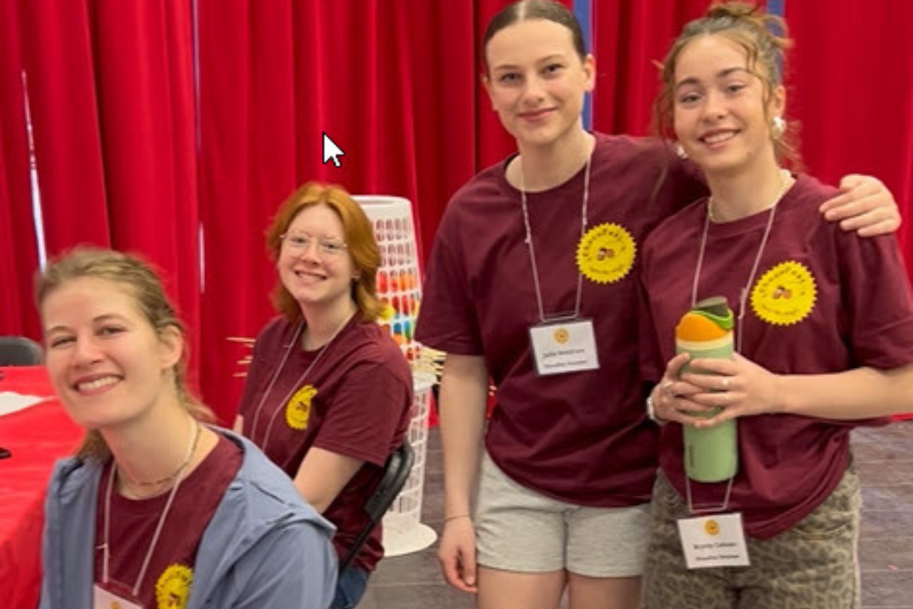 Smiling volunteers at ChocoFest wearing their Chocolateer Tshirts